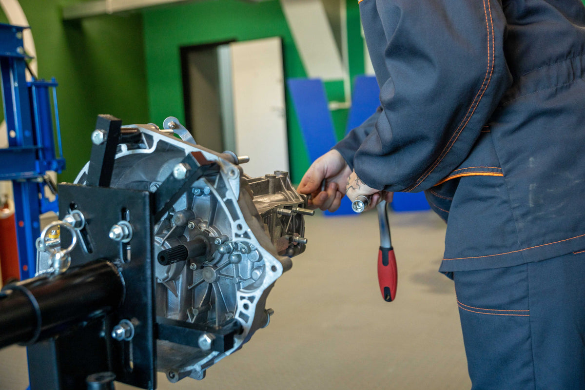 Mechanic working on a vehicle transmission and clutch system
