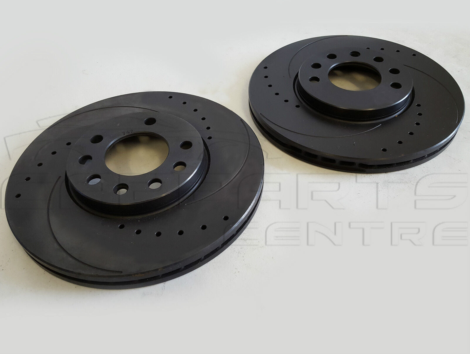 Two black Vauxhall Calibra 2.5 V6 front drilled grooved vented brake rotors